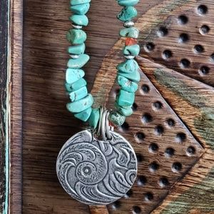 Turquoise beaded necklace with large silver pendan